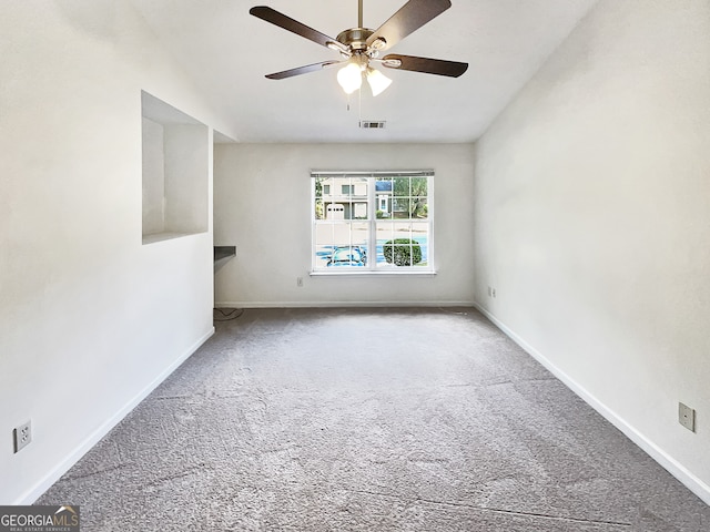 empty room featuring ceiling fan and carpet