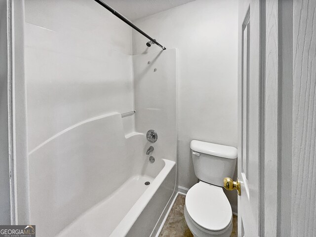 bathroom with toilet and washtub / shower combination