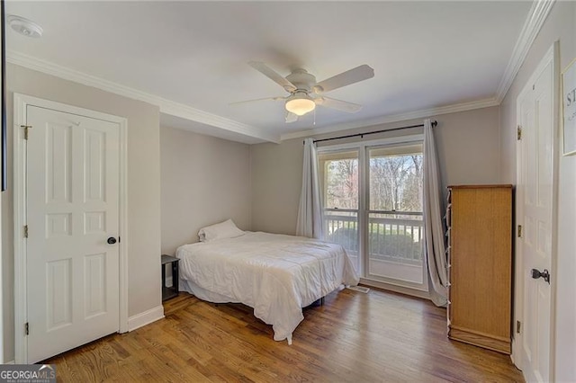 bedroom featuring ceiling fan, crown molding, access to exterior, and wood-type flooring