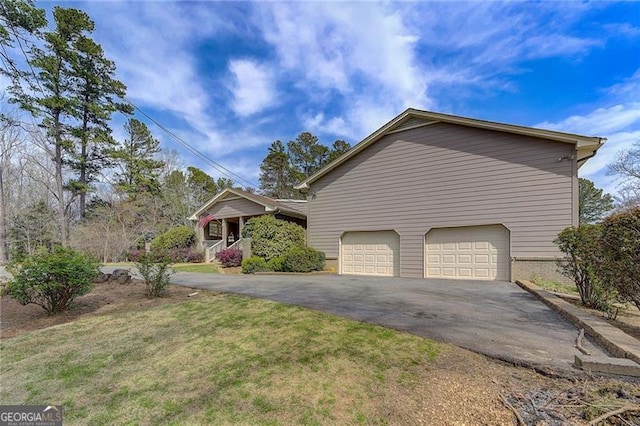 view of side of home with a yard and a garage