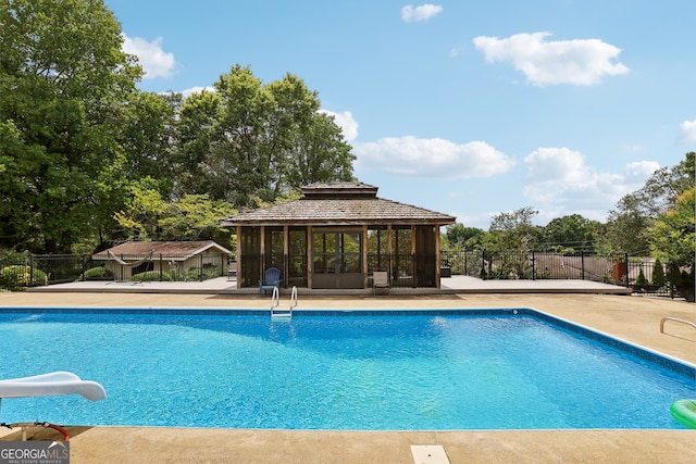 view of pool with a water slide and a gazebo