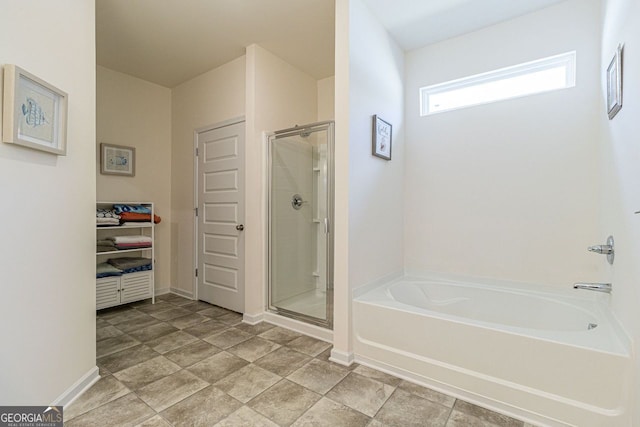 bathroom featuring plus walk in shower and tile flooring