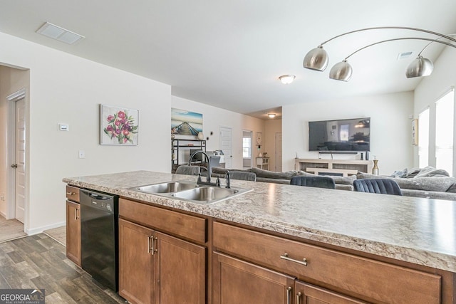 kitchen with dark hardwood / wood-style flooring, sink, a wealth of natural light, and dishwasher