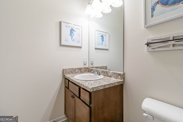 bathroom with toilet and vanity