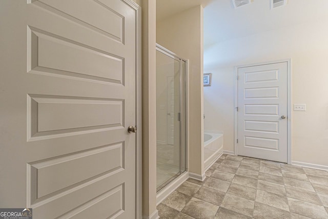 bathroom with tile flooring and plus walk in shower