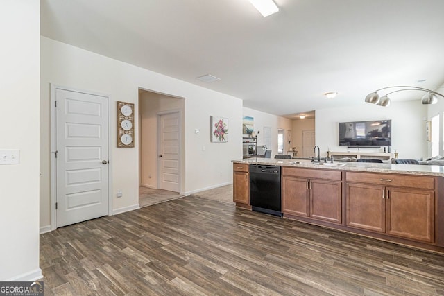 kitchen featuring light stone countertops, sink, dishwasher, and dark hardwood / wood-style flooring