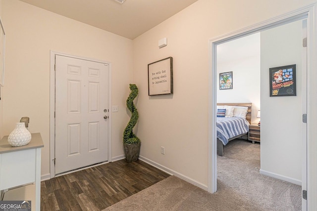 entryway featuring dark colored carpet