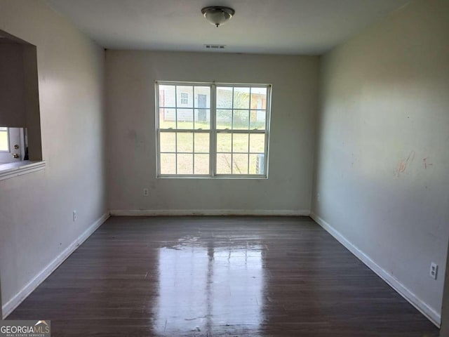 empty room featuring dark wood-type flooring