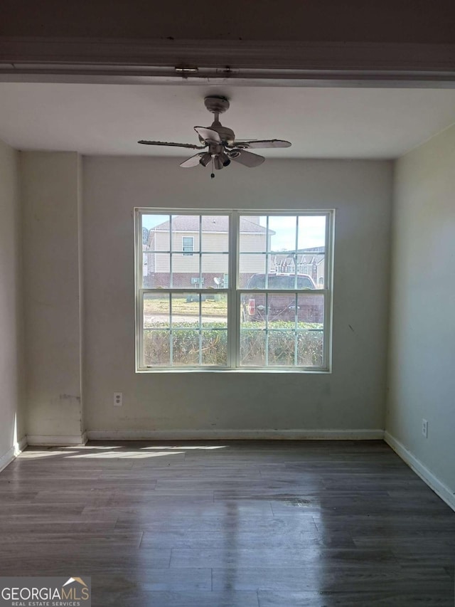 unfurnished room with dark hardwood / wood-style flooring and ceiling fan