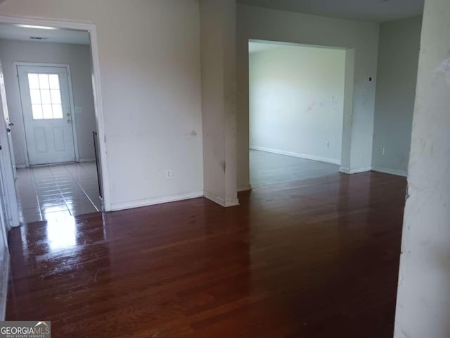 unfurnished room featuring dark hardwood / wood-style floors