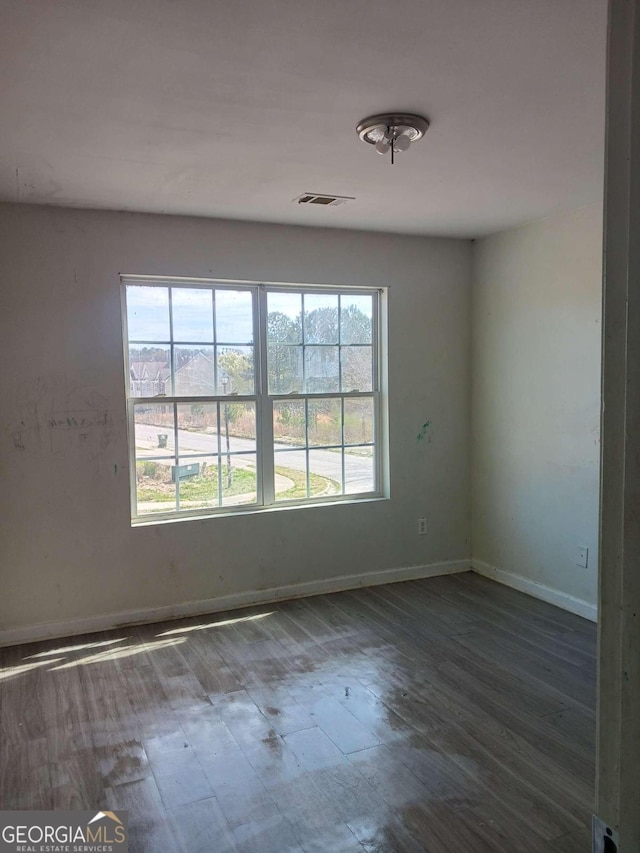 empty room with dark wood-type flooring