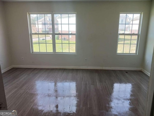 spare room with dark hardwood / wood-style flooring