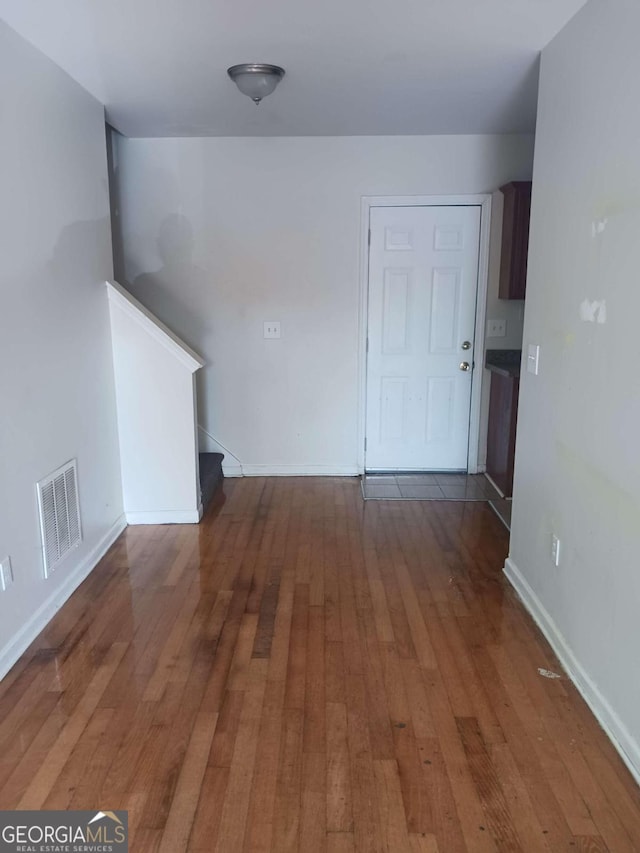 spare room with dark wood-type flooring