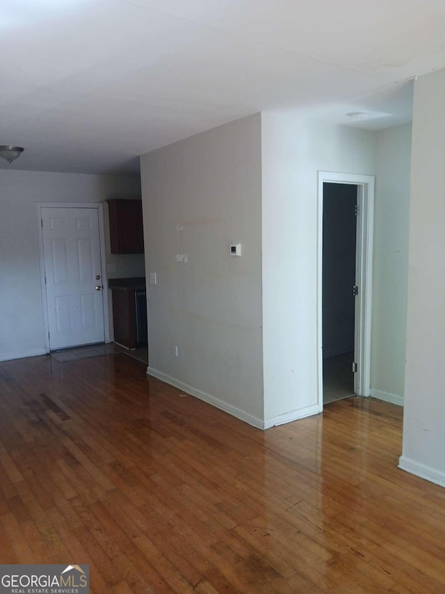 empty room with dark hardwood / wood-style floors