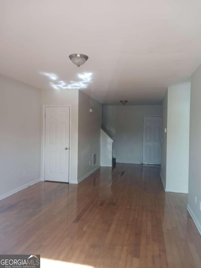 spare room with dark hardwood / wood-style flooring