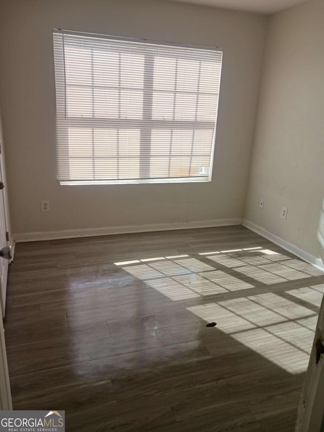 spare room featuring dark hardwood / wood-style flooring