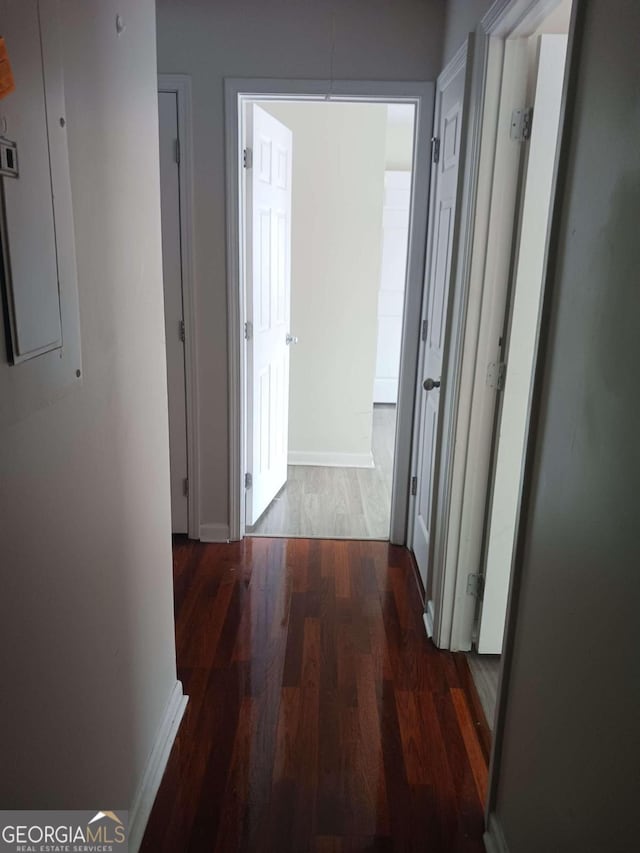 corridor featuring dark hardwood / wood-style flooring