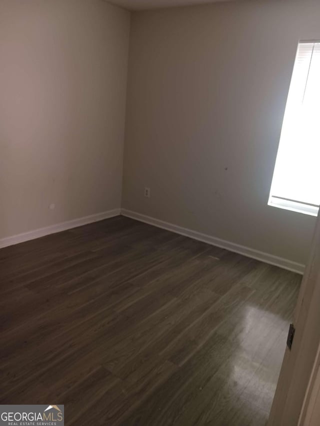 spare room with dark hardwood / wood-style flooring