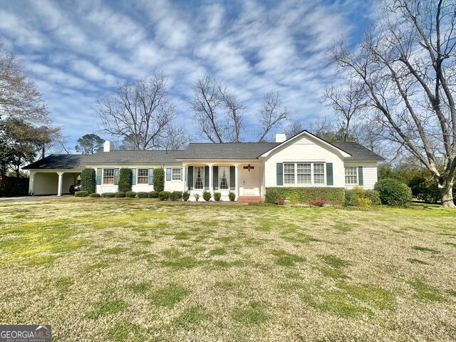 single story home featuring a front lawn