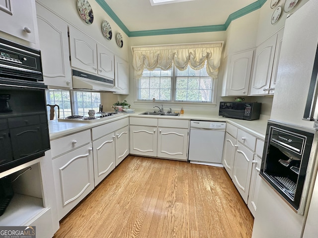 kitchen with white cabinets, crown molding, black appliances, and light wood-type flooring