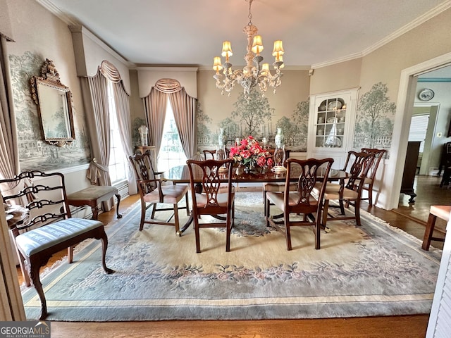 dining room with a notable chandelier, light wood-type flooring, and ornamental molding