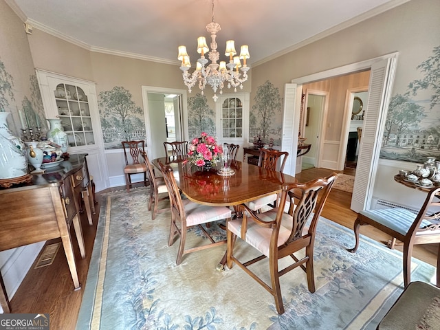 dining area with a chandelier, crown molding, and dark wood-type flooring