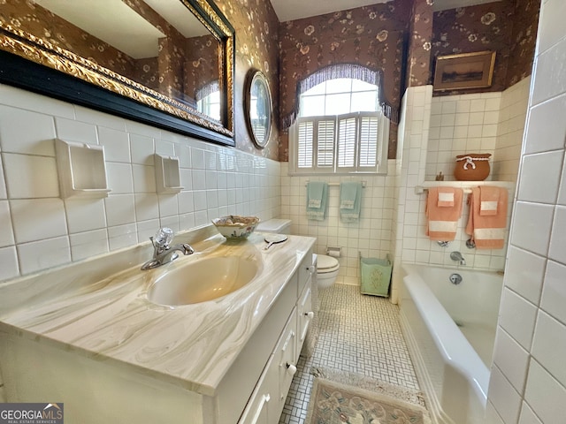 bathroom with tile walls, tile floors, toilet, and oversized vanity