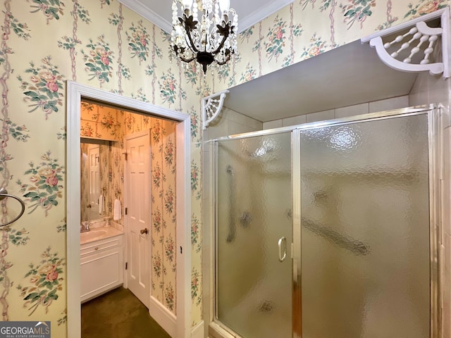 bathroom featuring a shower with shower door, a notable chandelier, sink, and crown molding