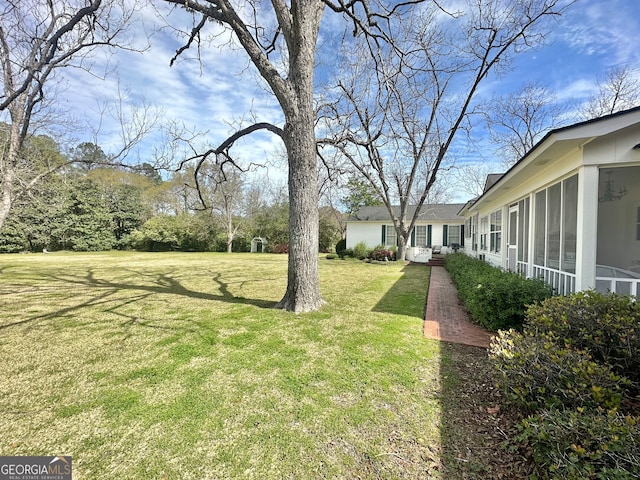 view of yard with a sunroom