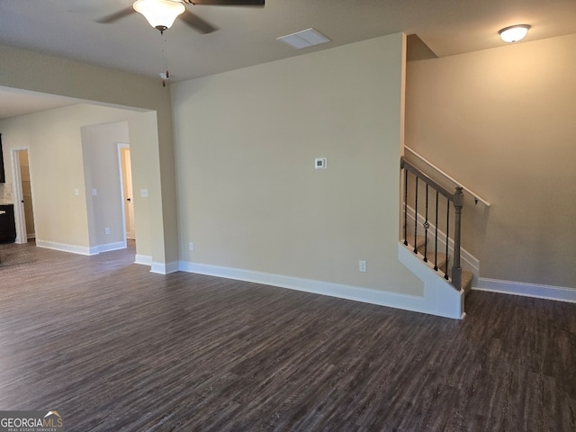 unfurnished living room featuring dark hardwood / wood-style floors and ceiling fan