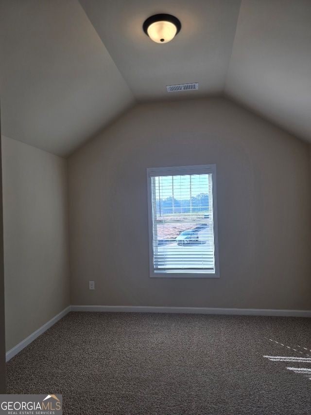 bonus room with carpet floors and vaulted ceiling