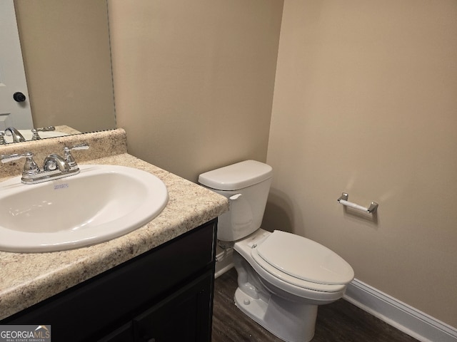 bathroom featuring hardwood / wood-style flooring, vanity, and toilet