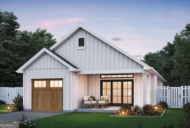 exterior space featuring a garage, board and batten siding, a yard, and fence