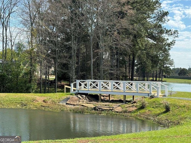 view of dock featuring a water view and an outdoor fire pit