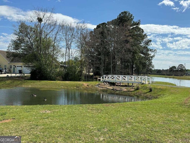 property view of water featuring an outdoor fire pit