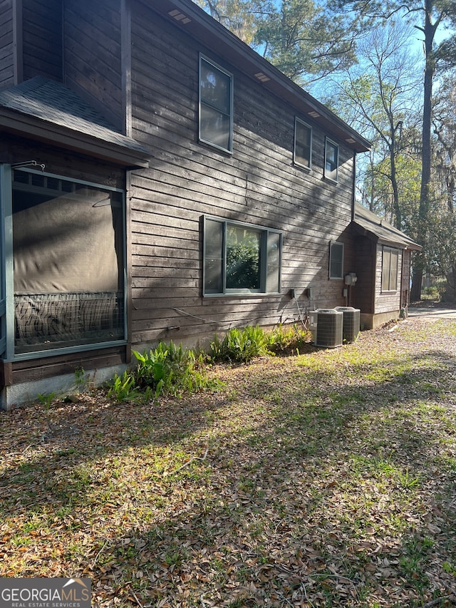 view of side of property with central AC unit