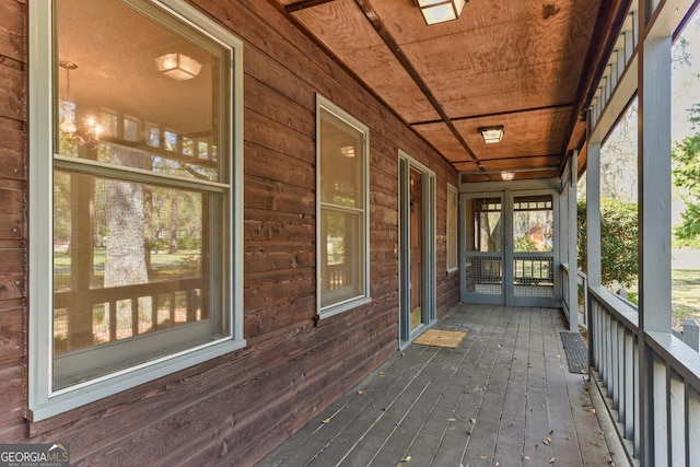 unfurnished sunroom featuring wooden ceiling