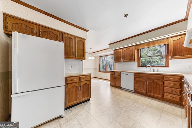 kitchen featuring white appliances, sink, light tile floors, ornamental molding, and tasteful backsplash