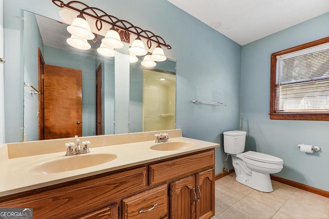 bathroom featuring double sink vanity, toilet, and tile floors