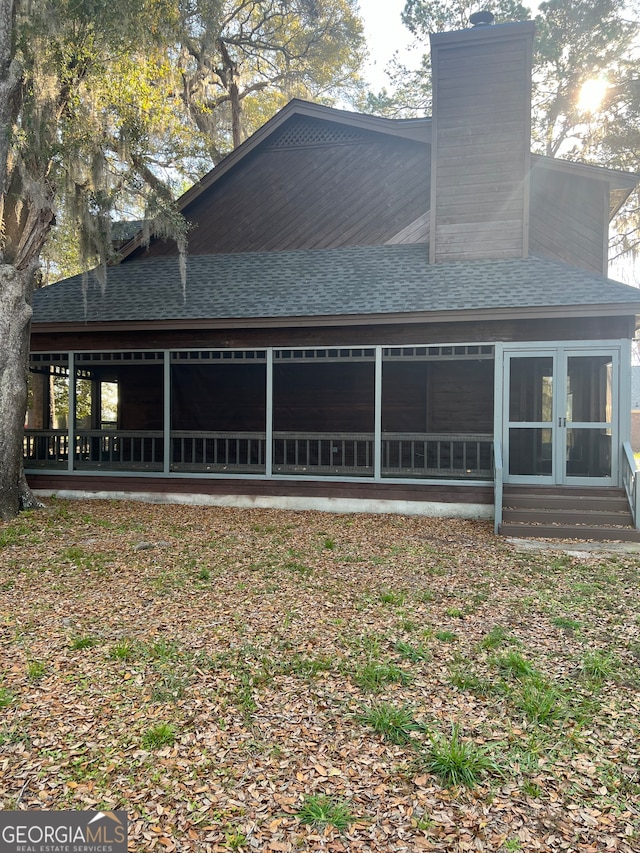 back of house with a sunroom