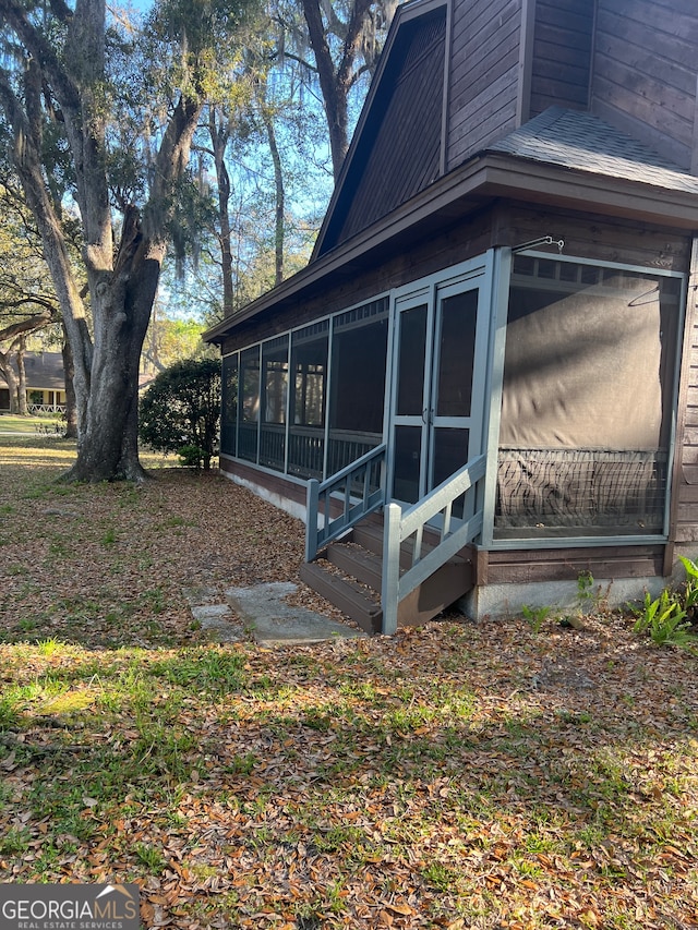 view of side of home with a sunroom