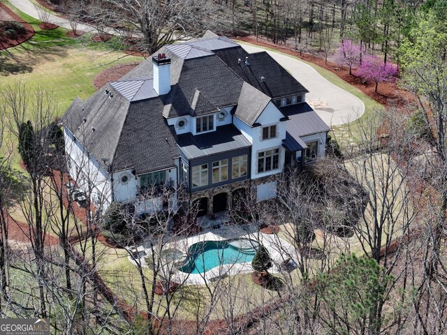 113 Hawks Ct, Ball Ground, GA 30107 - back of house featuring a sunroom, a chimney, an outdoor pool, and stone siding