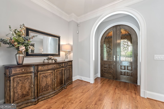 113 Hawks Ct, Ball Ground, GA 30107 - entrance foyer featuring arched walkways, crown molding, and light wood-type flooring
