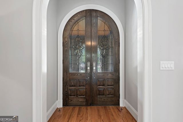 113 Hawks Ct, Ball Ground, GA 30107 - foyer featuring arched walkways and wood finished floors