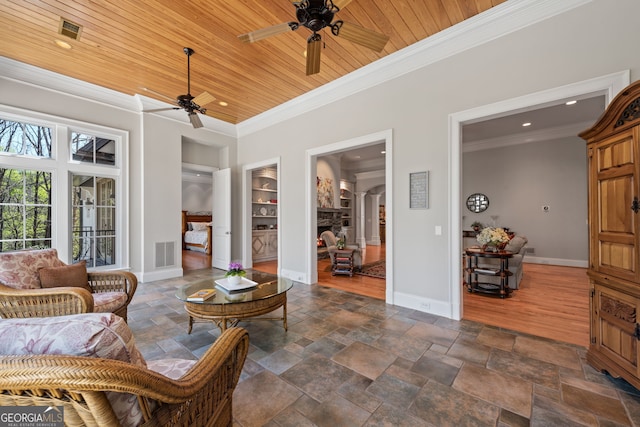 interior space with dark tile floors, ceiling fan, wood ceiling, and ornamental molding