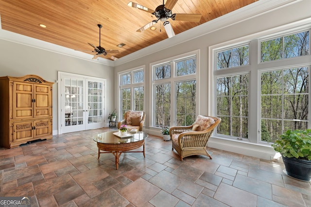 sunroom / solarium with a wealth of natural light, wood ceiling, and ceiling fan