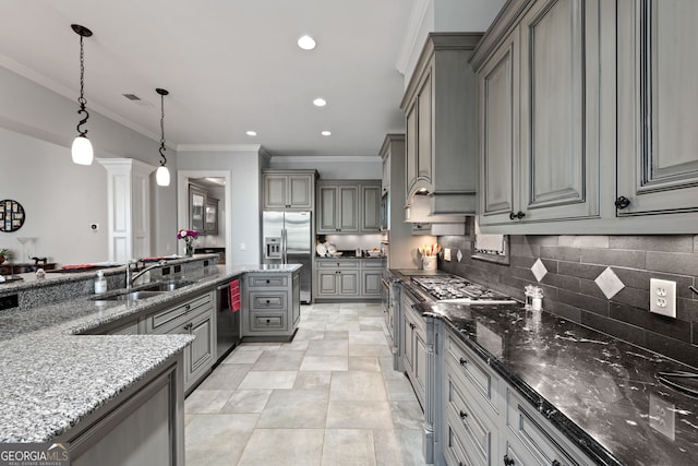 kitchen featuring pendant lighting, gray cabinetry, light stone counters, sink, and appliances with stainless steel finishes