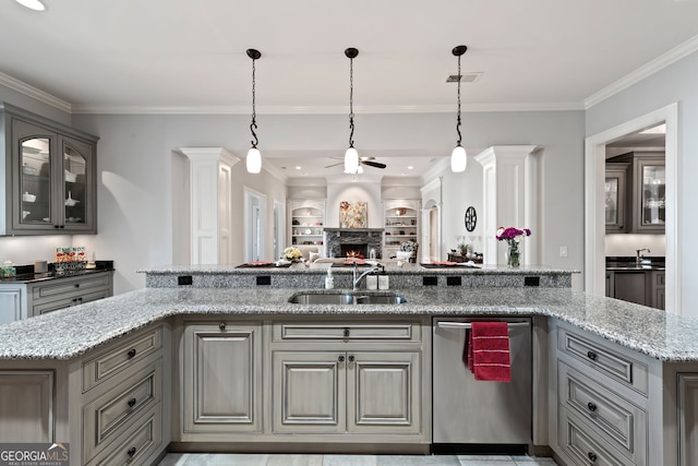 kitchen with sink, pendant lighting, dishwasher, and light stone countertops