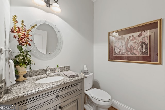 bathroom with toilet and vanity