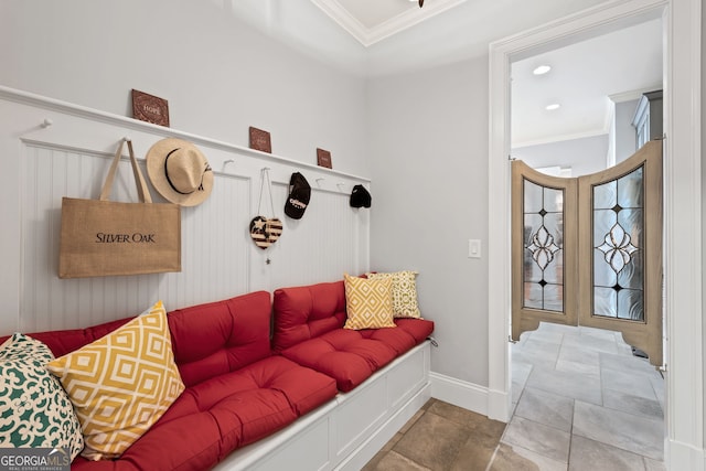 mudroom with tile floors and crown molding